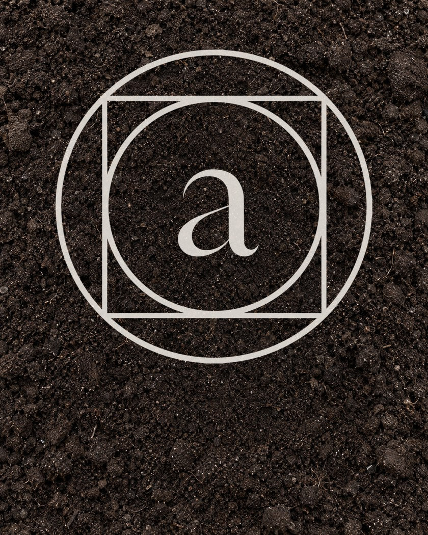 The Ankhway monogram drawn on dark soil
