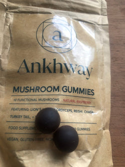 Package labeled 'Ankhway Mushroom Gummies' with two dark spherical gummies on top.