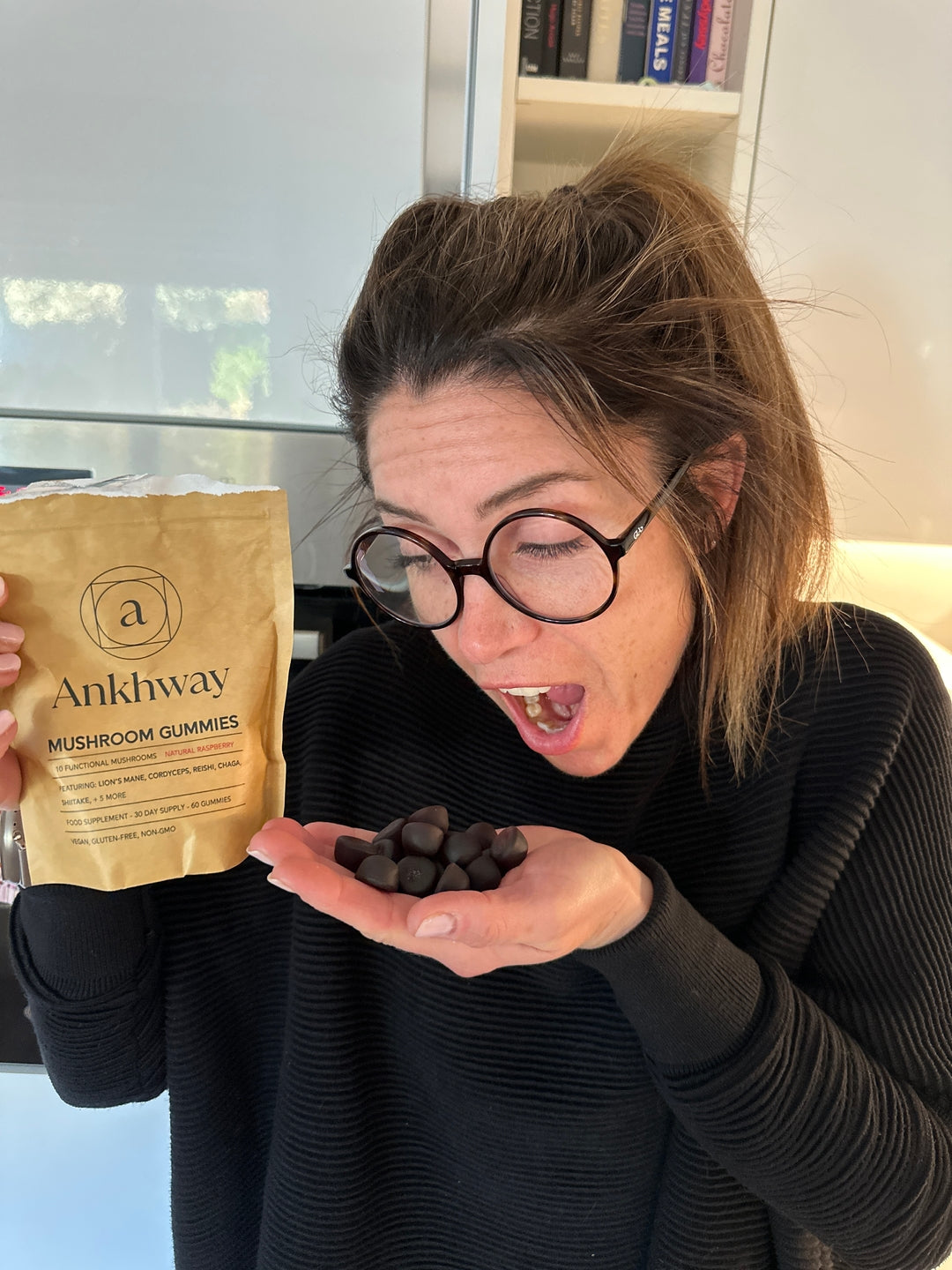 Woman holding Ankhway mushroom gummies
