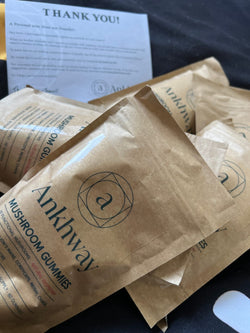 Bags of Ankhway mushroom gummies with a thank you note in the background.